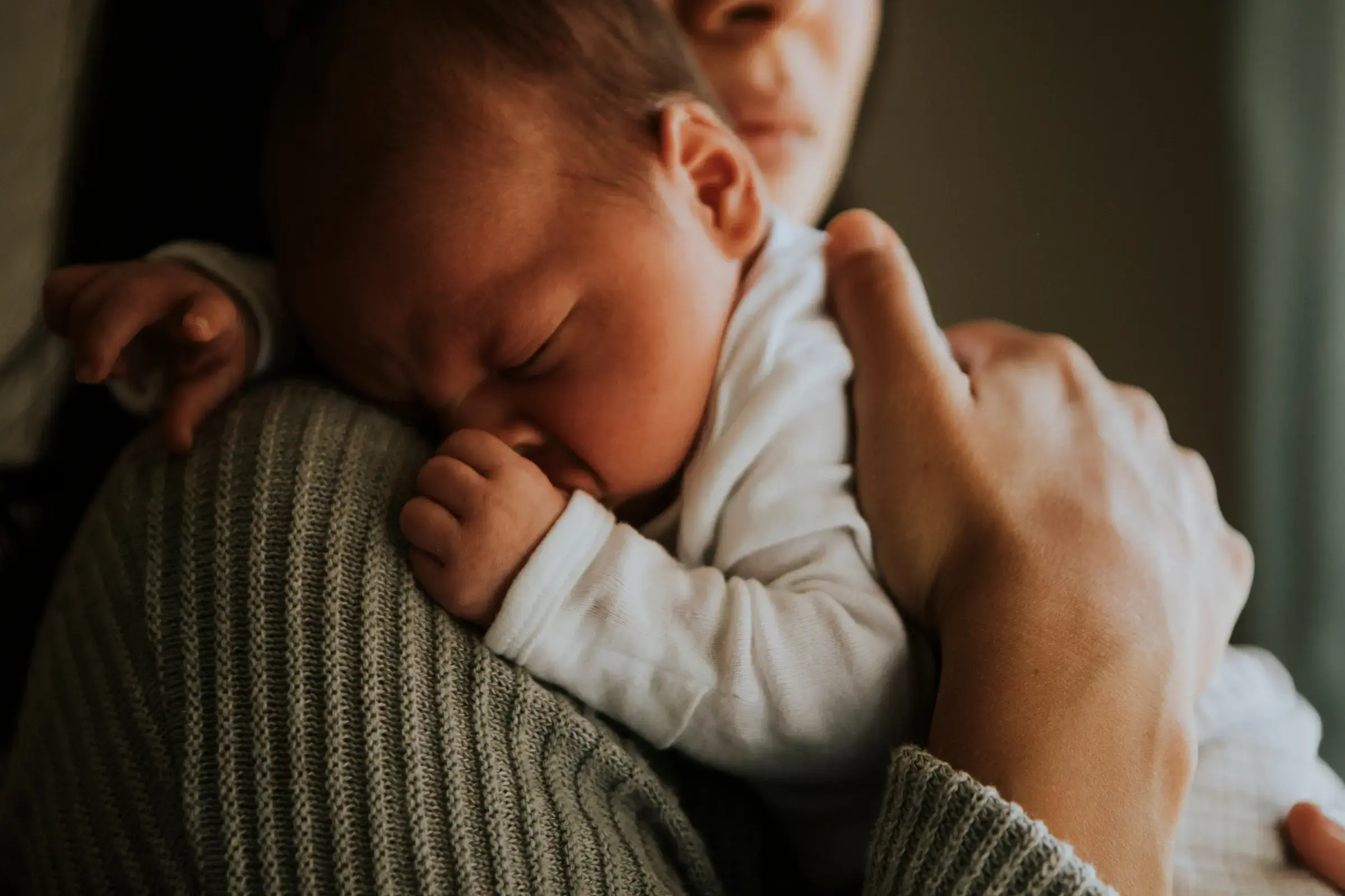 A peaceful sleeping baby on soft white bedding
